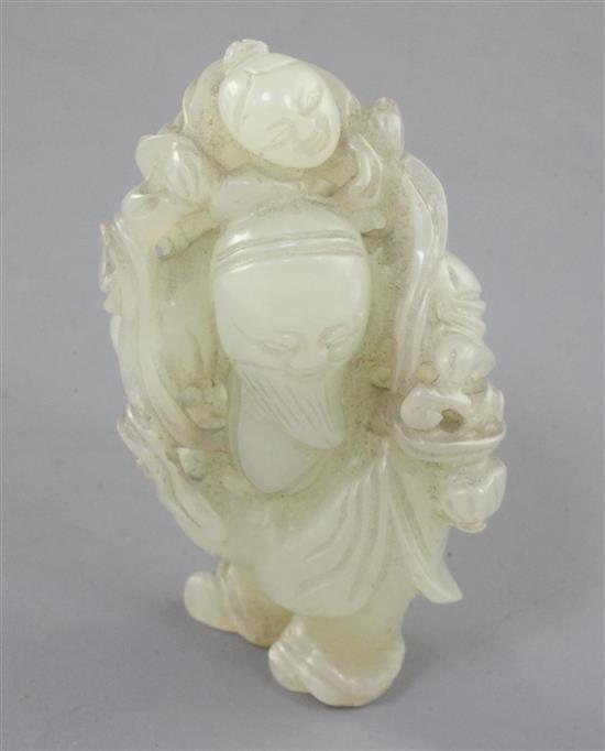 A Chinese pale celadon jade group of a sage with a boy on his back, 18th/19th century, height 5.2cm, wood stand